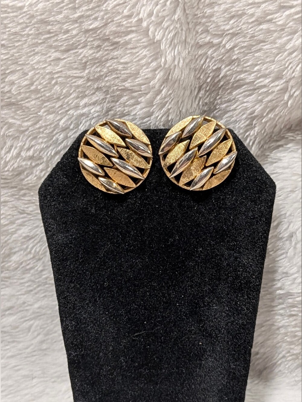 Vintage Trifari two-tone woven-style round button clip-on earrings.